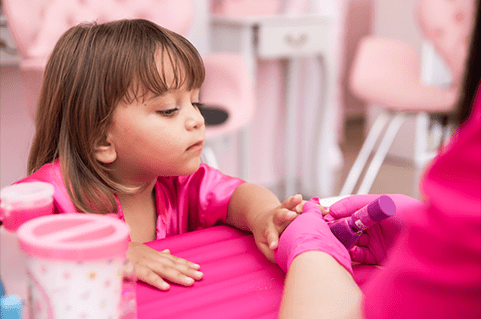 young girl getting manicure